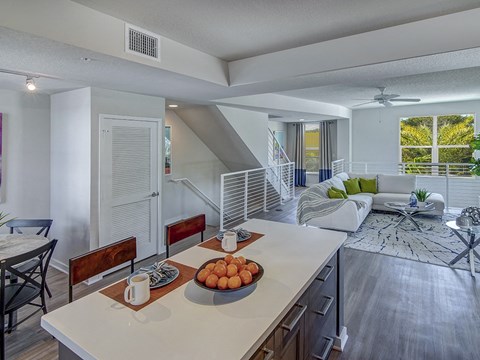 a kitchen and living room with a couch and a table